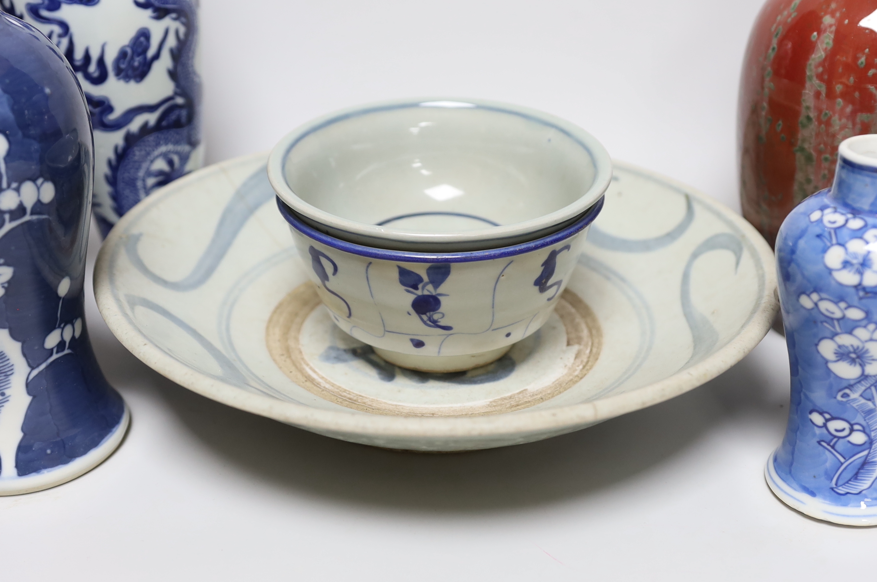 A group of Chinese blue and white ceramics including two prunus flower vases and three bowls and a Chinese flambe vase and a similar bowl